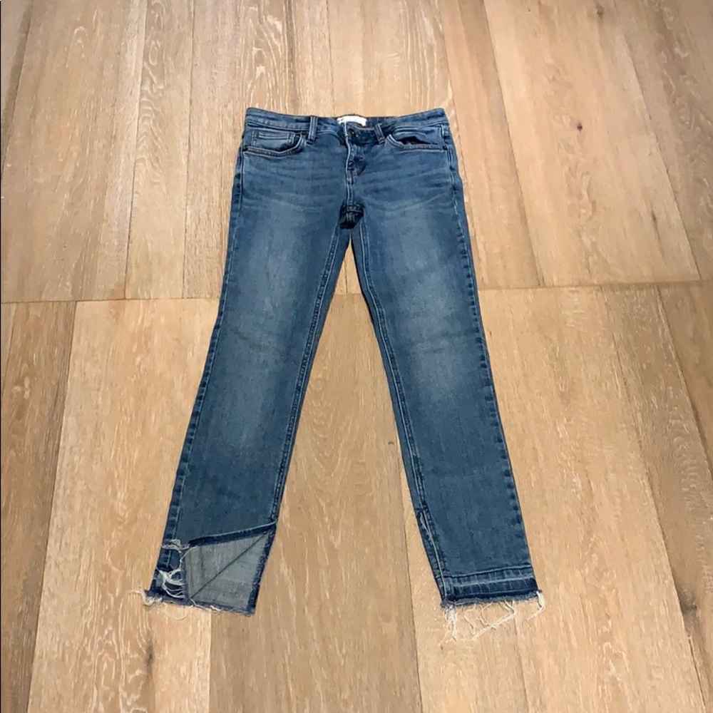 Medium wash, slit & fringe skinny jeans